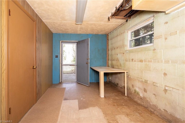 interior space with light floors and concrete block wall