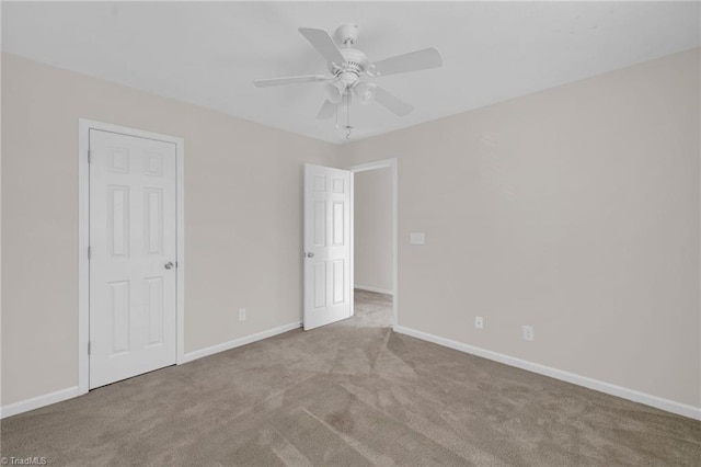 carpeted empty room with ceiling fan