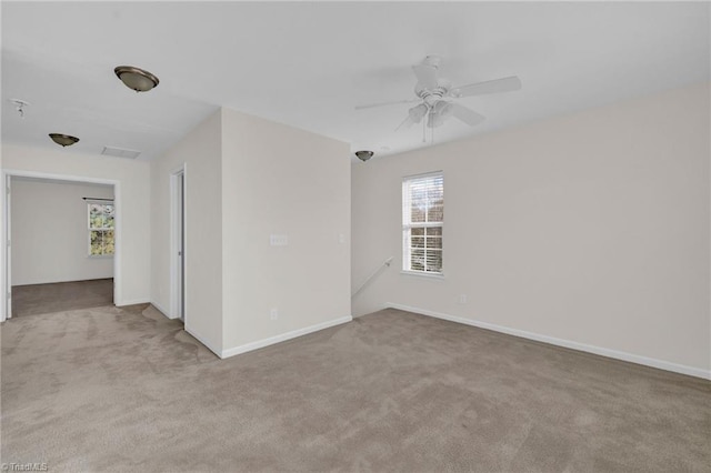 unfurnished room featuring light carpet