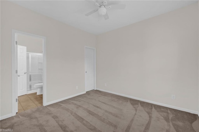 carpeted spare room with ceiling fan