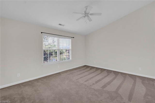 empty room featuring ceiling fan, carpet flooring, and vaulted ceiling