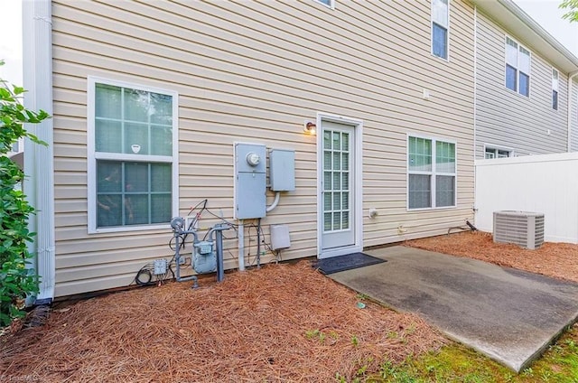 rear view of property featuring central AC and a patio area