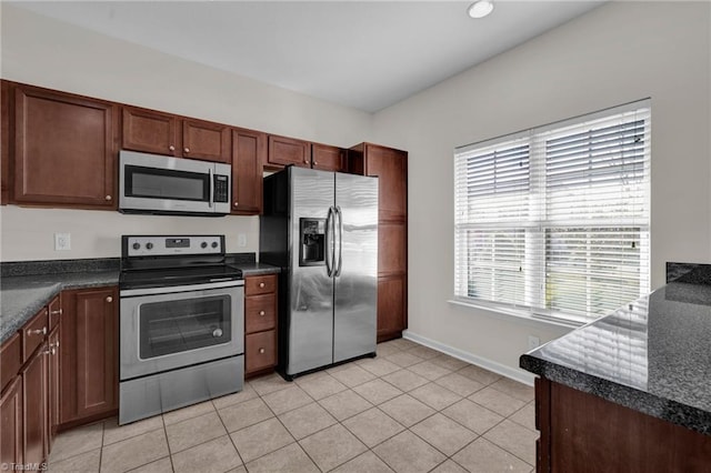 kitchen with appliances with stainless steel finishes and light tile patterned floors