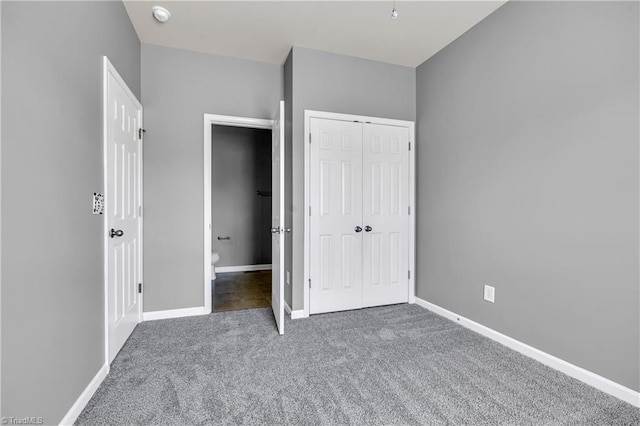 unfurnished bedroom featuring baseboards, a closet, and carpet floors