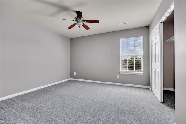 unfurnished bedroom featuring ceiling fan, carpet, baseboards, and visible vents