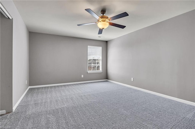spare room featuring baseboards, a ceiling fan, and carpet floors