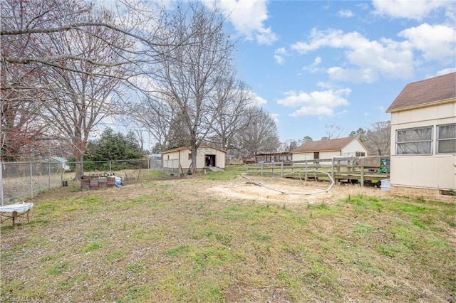 view of yard with an outbuilding and fence