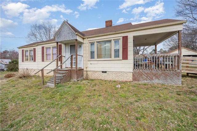 view of front of property with crawl space, a chimney, and a front yard