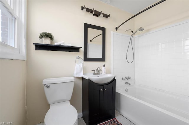 full bathroom featuring vanity, tiled shower / bath combo, and toilet