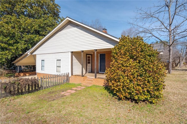 rear view of house featuring a yard