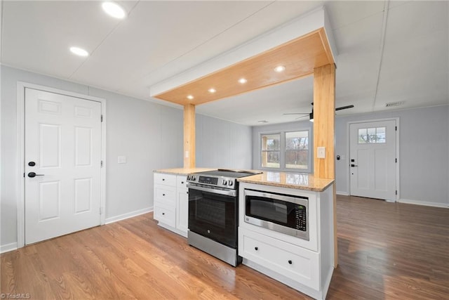 kitchen featuring visible vents, appliances with stainless steel finishes, white cabinetry, and light wood-style floors