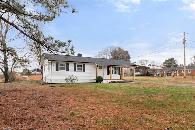 single story home featuring covered porch, crawl space, a carport, a front lawn, and a chimney