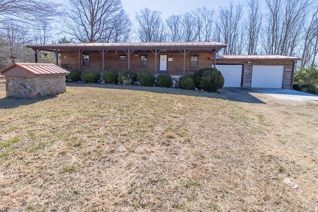 ranch-style home featuring a garage, driveway, a porch, and a front lawn