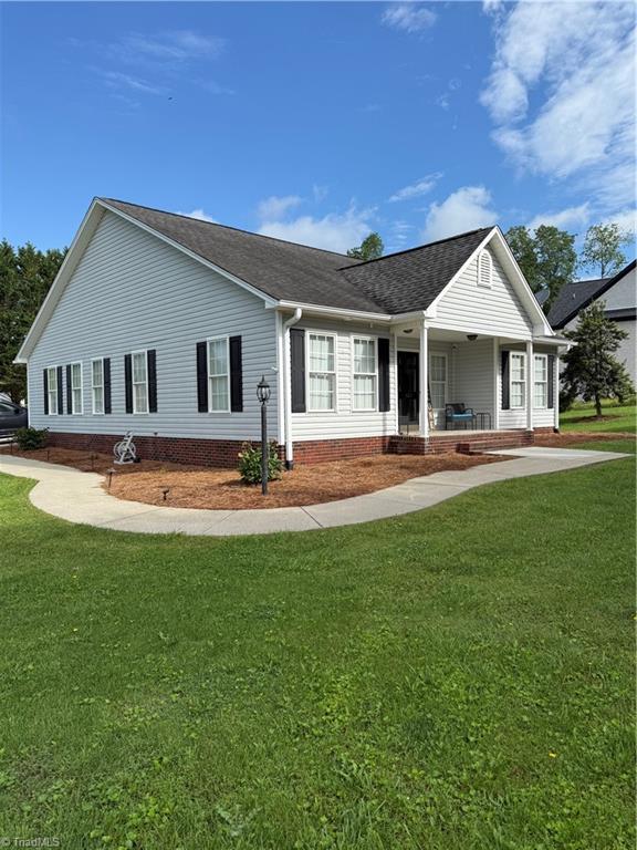 525 Bennett St, Mount Airy, NC 27030 - view of property exterior featuring roof with shingles, a porch, and a lawn