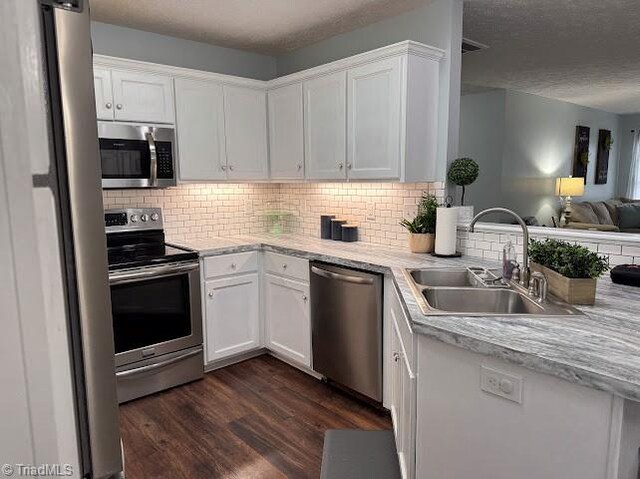 525 Bennett St, Mount Airy, NC 27030 - kitchen with stainless steel appliances, a sink, open floor plan, white cabinetry, and light countertops