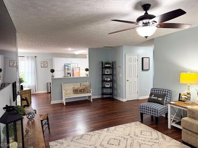 525 Bennett St, Mount Airy, NC 27030 - living area featuring ceiling fan, a textured ceiling, wood finished floors, baseboards, and radiator
