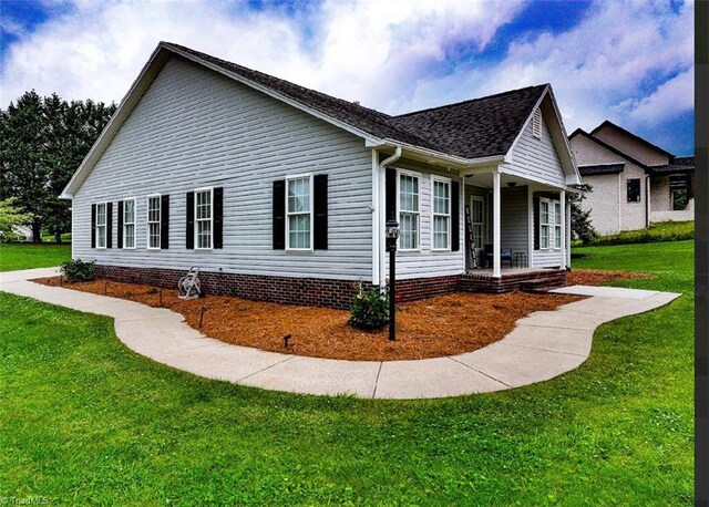525 Bennett St, Mount Airy, NC 27030 - view of property exterior featuring a lawn, covered porch, and roof with shingles