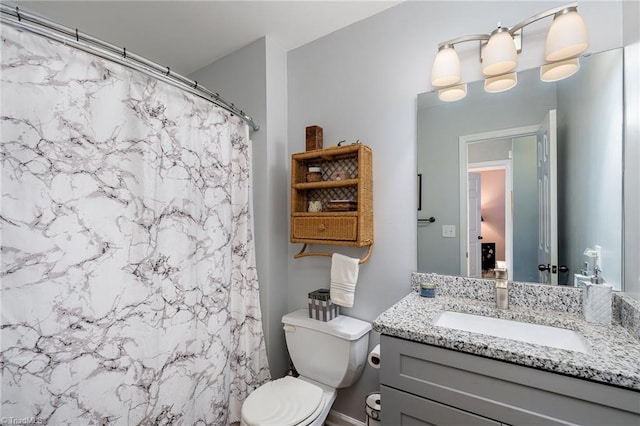 bathroom featuring a shower with shower curtain, vanity, and toilet