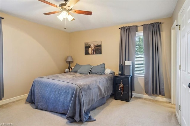 bedroom with light carpet and ceiling fan