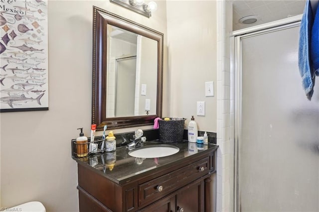 bathroom with a shower with door and vanity