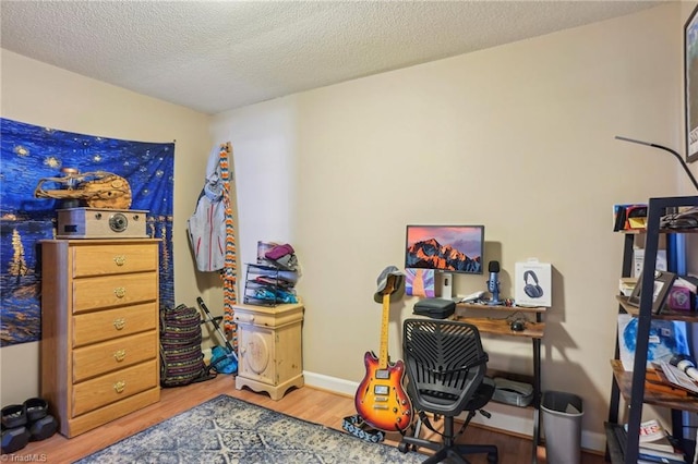 office space featuring hardwood / wood-style flooring and a textured ceiling