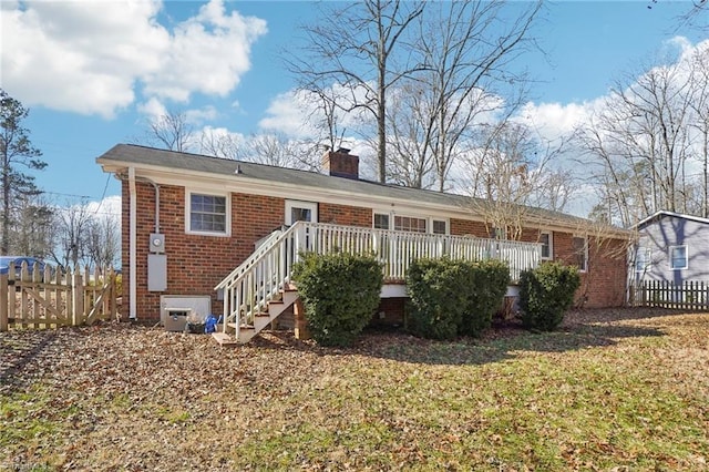 back of property featuring a yard and a deck