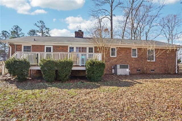 rear view of property with a wooden deck, a yard, and central AC