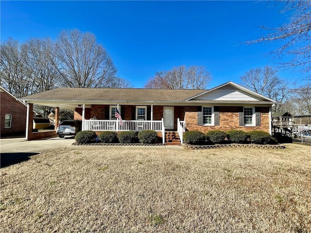 ranch-style house featuring a carport, a porch, and a front lawn