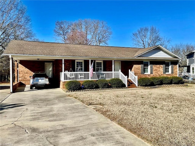 ranch-style home with a carport and covered porch