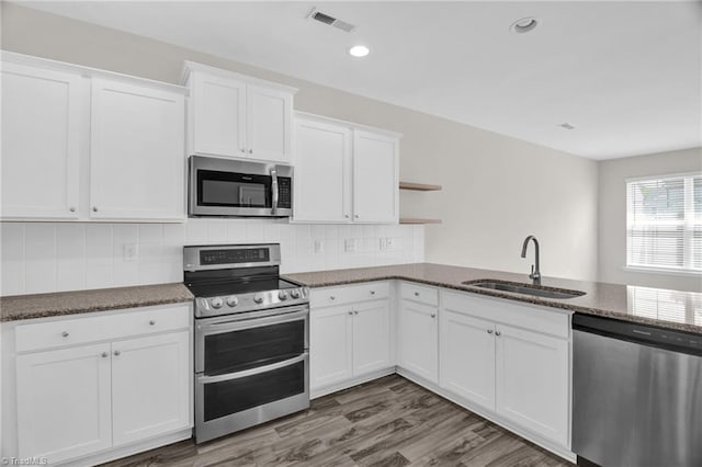 1442 Crestlawn Trl, Pfafftown, NC 27040 - kitchen featuring open shelves, white cabinets, dark stone countertops, a sink, and stainless steel appliances
