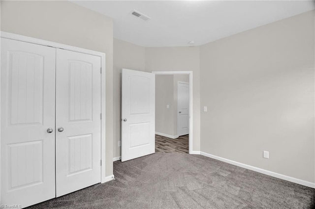 1442 Crestlawn Trl, Pfafftown, NC 27040 - unfurnished bedroom featuring a closet, baseboards, carpet flooring, and visible vents