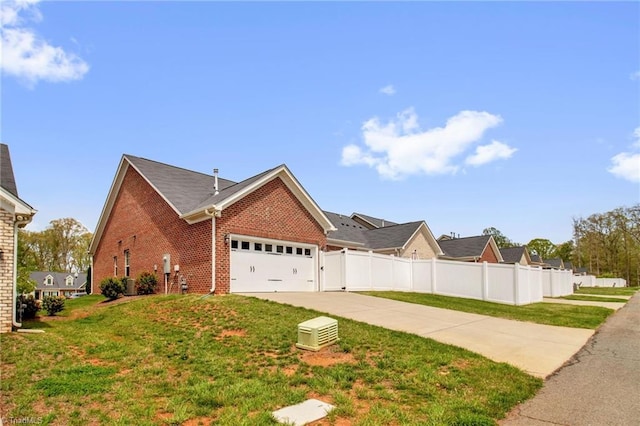 1442 Crestlawn Trl, Pfafftown, NC 27040 - view of home's exterior featuring a yard, an attached garage, fence, brick siding, and driveway