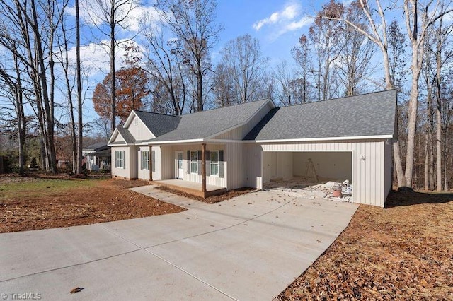 ranch-style house with covered porch and a garage