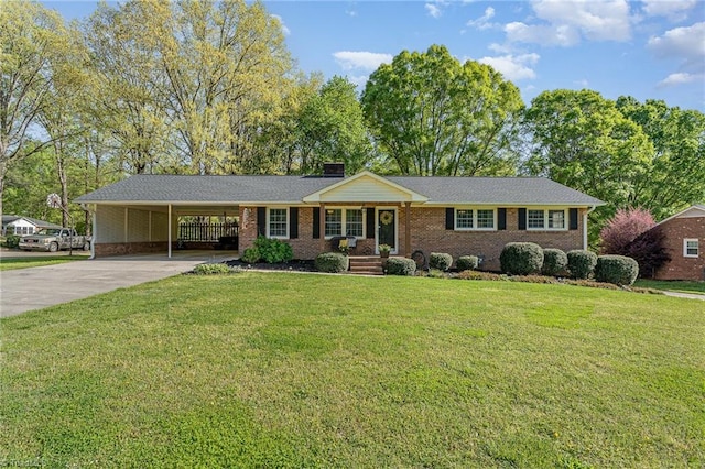 single story home with concrete driveway, a front yard, brick siding, and a carport