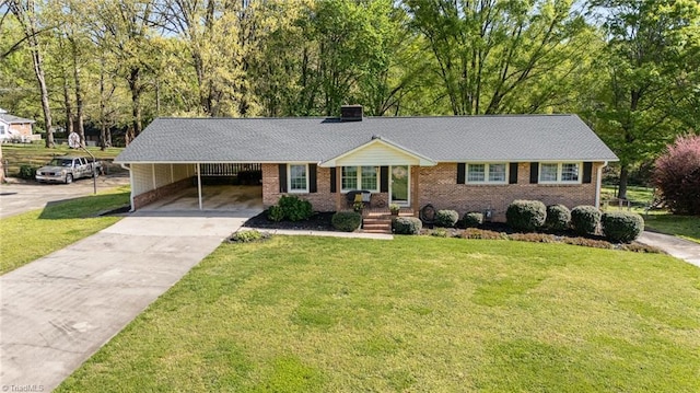 ranch-style home with concrete driveway, brick siding, and a front lawn