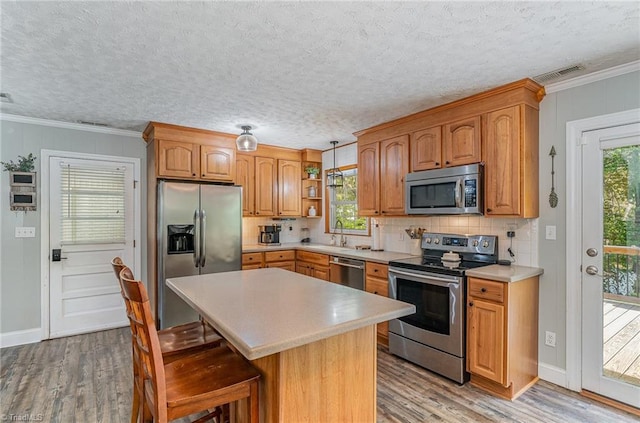 kitchen featuring light wood-style flooring, light countertops, open shelves, visible vents, and appliances with stainless steel finishes