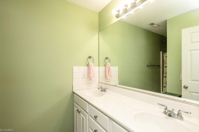 bathroom featuring double vanity, visible vents, backsplash, and a sink