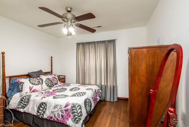 bedroom featuring baseboards, ceiling fan, visible vents, and dark wood-type flooring