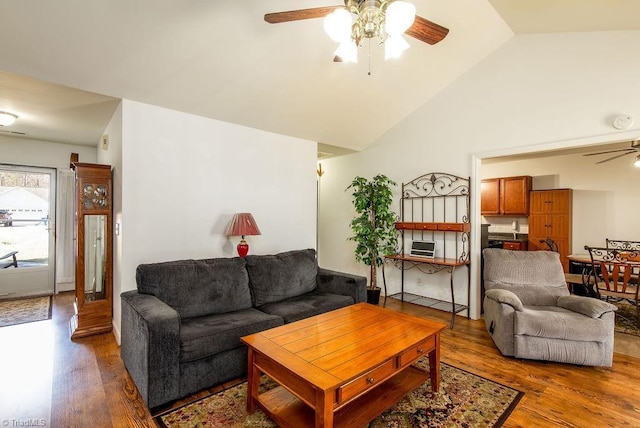 living room featuring lofted ceiling, ceiling fan, and wood finished floors