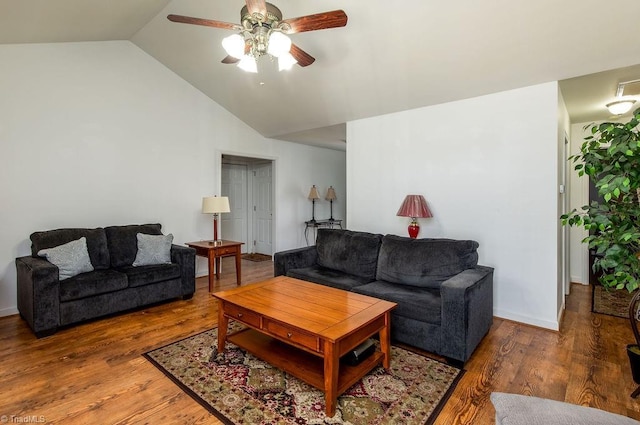 living room with lofted ceiling, dark wood-style floors, a ceiling fan, and baseboards