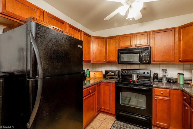 kitchen with light tile patterned floors, black appliances, dark countertops, and backsplash