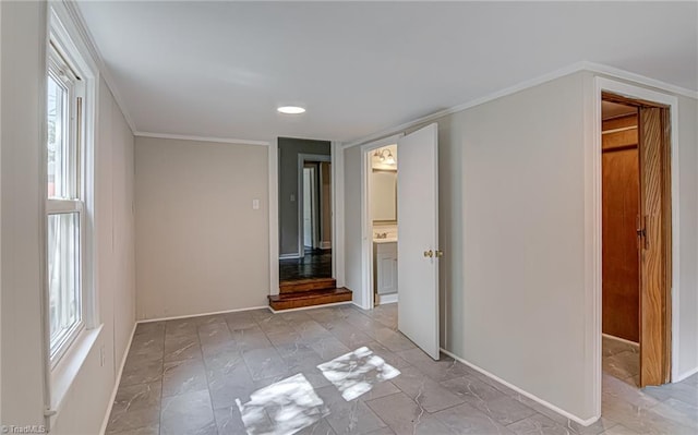 spare room featuring a healthy amount of sunlight and crown molding