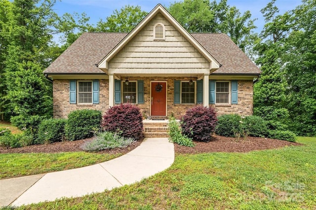 845 Montgomery Ct, Walnut Cove, NC 27052 - view of front of property featuring a front lawn, brick siding, and a shingled roof