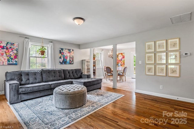 845 Montgomery Ct, Walnut Cove, NC 27052 - living room with healthy amount of natural light, wood finished floors, baseboards, and a chandelier