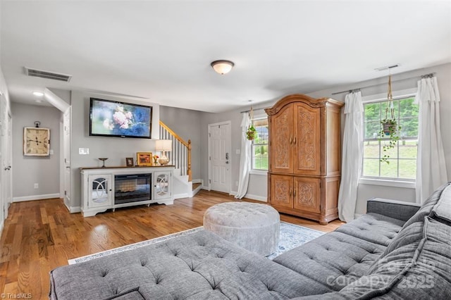 845 Montgomery Ct, Walnut Cove, NC 27052 - living area featuring stairway, light wood finished floors, and baseboards
