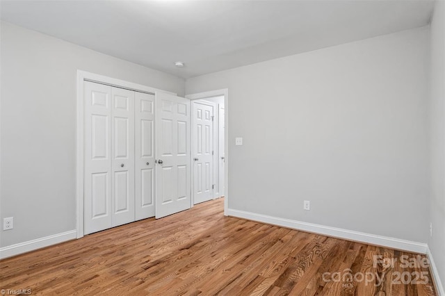 845 Montgomery Ct, Walnut Cove, NC 27052 - unfurnished bedroom featuring baseboards and light wood-type flooring