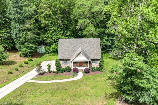 845 Montgomery Ct, Walnut Cove, NC 27052 - view of front of house with covered porch, a front yard, stone siding, and driveway