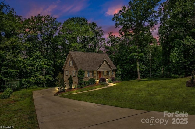 845 Montgomery Ct, Walnut Cove, NC 27052 - view of front of home with concrete driveway, a lawn, and brick siding