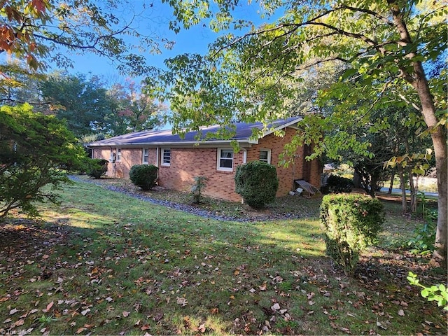 view of side of property with a lawn