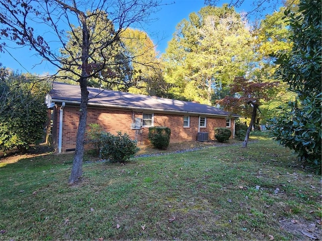 view of property exterior featuring cooling unit and a yard